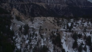 5K aerial stock footage of a mountain road with winter snow in the San Gabriel Mountains at twilight, California Aerial Stock Footage | AX0008_016