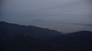 5K aerial stock footage video of San Gabriel Valley beyond the mountains at twilight, California Aerial Stock Footage | AX0008_048