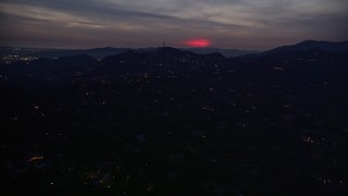 5K aerial stock footage of a red glow in clouds above hillside homes in La Cañada Flintridge at night, California Aerial Stock Footage | AX0008_070