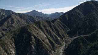 5K aerial stock footage of sharp mountain ridges to reveal road in San Gabriel Mountains of California Aerial Stock Footage | AX0009_011E