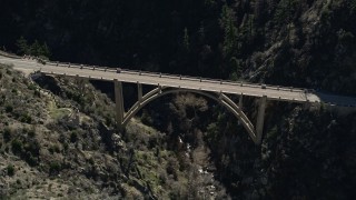 AX0009_023E - 5K aerial stock footage of orbiting a small bridge in the San Gabriel Mountains, California