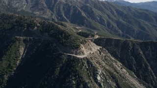 5K aerial stock footage descend toward a road in the San Gabriel Mountains, California Aerial Stock Footage | AX0009_037