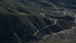 5K aerial stock footage orbit road at the base of slopes in the San Gabriel Mountains, California Aerial Stock Footage | AX0009_042