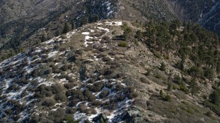 5K aerial stock footage fly over ridge with snow on shady side in the San Gabriel Mountains in winter, California Aerial Stock Footage | AX0009_053E