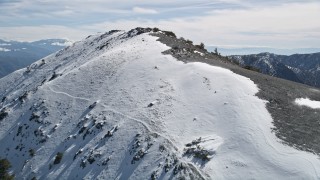 5K aerial stock footage approach and fly over summit of snow-capped peak in the San Gabriel Mountains, California Aerial Stock Footage | AX0009_062E