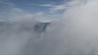 5K aerial stock footage of flying through a small cloud to reveal the San Bernardino Mountains, California Aerial Stock Footage | AX0009_073E