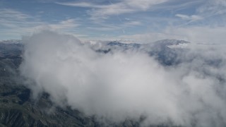 AX0009_075E - 5K aerial stock footage of approaching and flying over a cloud over the San Bernardino Mountains, California