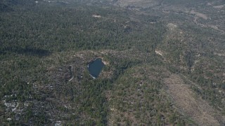 5K aerial stock footage orbit small lake and evergreen forest with winter snow in the San Bernardino Mountains, California Aerial Stock Footage | AX0009_125