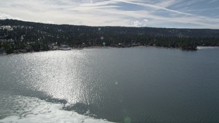 5K aerial stock footage fly over ice patch and tilt to reveal shore of Big Bear Lake, California Aerial Stock Footage | AX0010_017