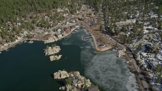 5K aerial stock footage approach waterfront homes and the town on the shore of Big Bear Lake in winter, California Aerial Stock Footage | AX0010_031