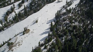 AX0010_041 - 5K aerial stock footage of skiers and lift at the Snow Summit Ski Resort in winter, California