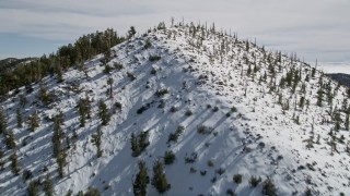 5K aerial stock footage fly over snowy mountains to approach low cloud bank in the San Bernardino Mountains, California Aerial Stock Footage | AX0010_067