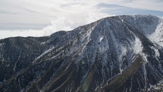 5K aerial stock footage orbit snowy peak in the San Jacinto Mountains in winter, California Aerial Stock Footage | AX0010_068