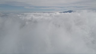 5K aerial stock footage tilt up from clouds to reveal distant peak in San Jacinto Mountains, California Aerial Stock Footage | AX0010_072