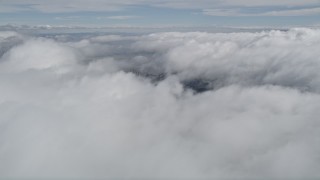 5K aerial stock footage of orbiting above thick cloud cover in Southern California Aerial Stock Footage | AX0010_076