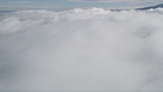 5K aerial stock footage tilt up and fly over thick cloud cover in Southern California  Aerial Stock Footage | AX0010_077