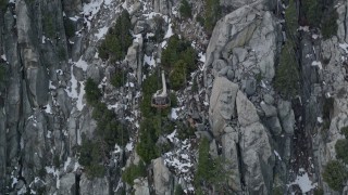 AX0010_115E - 5K aerial stock footage of tracking gondola heading up the San Jacinto Mountains, California