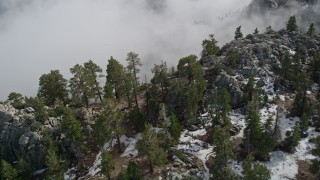 5K aerial stock footage pan across snow and boulders on a San Jacinto Mountains slope in winter, California Aerial Stock Footage | AX0010_118