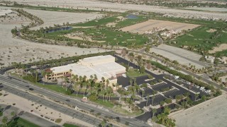 AX0010_147 - 5K aerial stock footage approach and orbit museum and office building in East Palm Springs, California