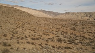 AX0011_012 - 5K aerial stock footage fly low over desert plants at Joshua Tree National Park, California