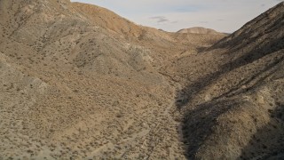 5K aerial stock footage of a canyon between desert mountains in Joshua Tree National Park, California Aerial Stock Footage | AX0011_018E