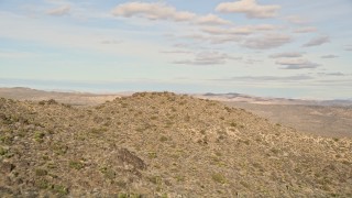 AX0011_028E - 5K aerial stock footage of flying over a rock formation, Joshua Tree National Park, California