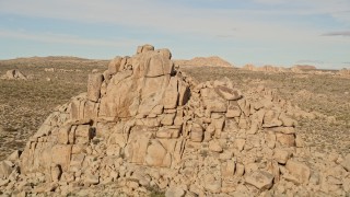 AX0011_031 - 5K aerial stock footage fly over desert rock formation, Joshua Tree National Park, California