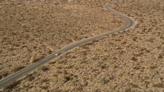 5K aerial stock footage of tracking a car on a desert road, Joshua Tree National Park, California Aerial Stock Footage | AX0011_043E