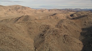 5K aerial stock footage orbiting desert mountains, Mojave Desert, California Aerial Stock Footage | AX0011_050