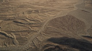 5K aerial stock footage pan across desert and tilt to rural area, Mojave Desert, California Aerial Stock Footage | AX0011_060