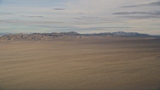 AX0011_068 - 5K aerial stock footage of a view across the Mojave Desert to mountains in California 