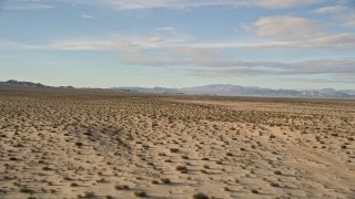 AX0011_073 - 5K aerial stock footage fly low over desert vegetation while descending, Mojave Desert, California