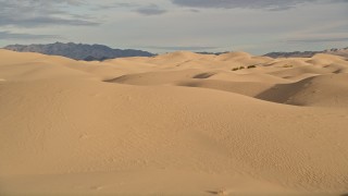 AX0012_006E - 5K aerial stock footage of flying over sand dunes, Kelso Dunes, California