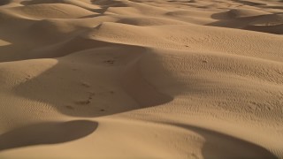 AX0012_009 - 5K aerial stock footage of flying over sand dunes, Kelso Dunes, Mojave Desert, California