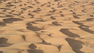 AX0012_010 - 5K aerial stock footage fly across sand dunes, Kelso Dunes, Mojave Desert, California