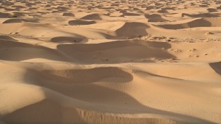 AX0012_011E - 5K aerial stock footage fly low over sand dunes, Kelso Dunes, Mojave Desert, California