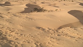 AX0012_016 - 5K aerial stock footage approach desert vegetation, Kelso Dunes, Mojave Desert, California