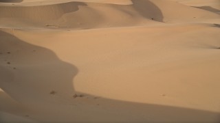 AX0012_025 - Aerial stock footage of 5K aerial  video fly low over sand dunes, Kelso Dunes, Mojave Desert, California