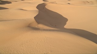 AX0012_032E - 5K aerial stock footage fly over sand dunes, Kelso Dunes, Mojave Desert, California