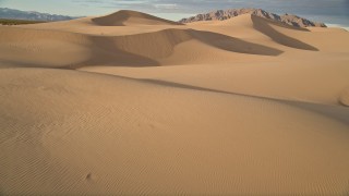 AX0012_034E - 5K aerial stock footage fly low over sand dunes, Kelso Dunes, Mojave Desert, California