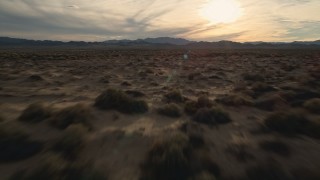 AX0012_041E - 5K aerial stock footage fly low over desert plain, Mojave Desert, California