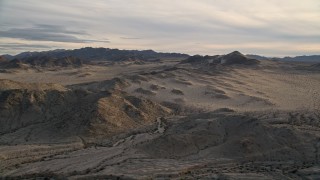 5K aerial stock footage fly by desert hills and mountains, Mojave Desert, California, sunset Aerial Stock Footage | AX0012_044