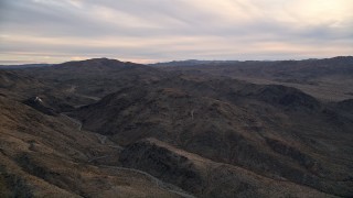 5K aerial stock footage fly by desert mountains, Mojave Desert, California, sunset Aerial Stock Footage | AX0012_058