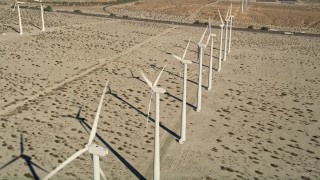 AX0013_023 - 5K aerial stock footage fly over a row of windmills, San Gorgonio Pass Wind Farm, California