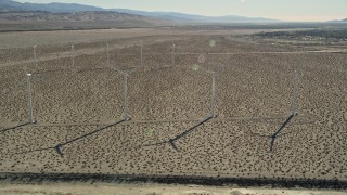 AX0013_031 - 5K aerial stock footage fly by windmills in the desert, San Gorgonio Pass Wind Farm, California