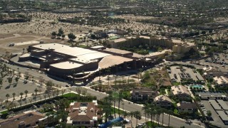 AX0013_037E - 5K aerial stock footage of fly over residential neighborhoods toward a convention center, West Palm Springs, California