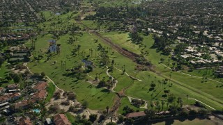 AX0013_041 - 5K aerial stock footage approach golf course, West Palm Springs, California