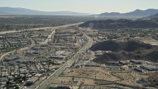 5K aerial stock footage of following a street past office buildings, Cathedral City, California Aerial Stock Footage | AX0013_055