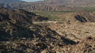 5K aerial stock footage fly over mountain toward a valley community, Indian Wells, California Aerial Stock Footage | AX0013_081