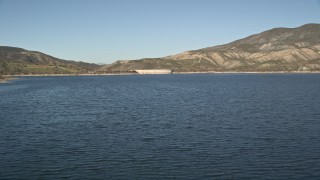 AX0014_027 - 5K aerial stock footage fly low over Lake Hemet and approach Hemet Dam, California